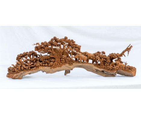 An Indian trunk carved wooden elephant scene, second half 20th century, the family of elephants walking through a leafy woode