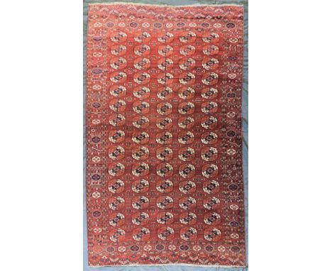 A Tekke Turkmen carpet, Emirate of Bukhara, circa 1880, the madder field with five columns of quartered guls enclosed by bord