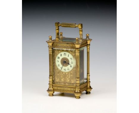 A French gilt brass carriage clock, c.1910, in a pillars case, with fluted columns, turned finials and applied blind fretwork