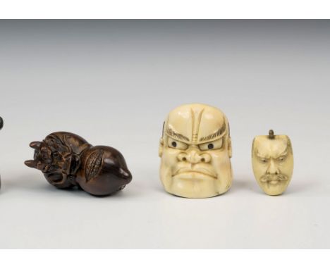 Two Japanese carved netsukes, Meiji period (1868-1912), comprising a carved ivory Beshimi mask, signed verso, 3.9cm. long; an