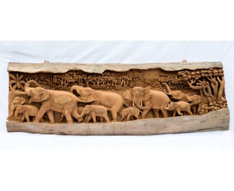 An Indian carved wooden elephant plaque, second half 20th century, the naturalistic split trunk deeply carved with a processi