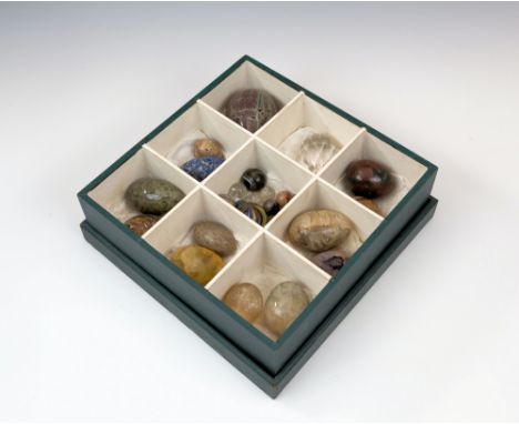 A collection of Victorian carved hardstone eggs and marbles, including thirteen eggs in lalis lazuli, Blue John, serpentine, 