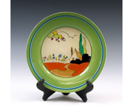 A Clarice Cliff Tulips pattern circular plate, circa 1934, hand painted with stylized cottage landscape on honeyglaze, green,