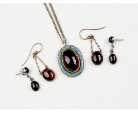 A Victorian yellow gold, garnet and enamel pendant, the 17 x 12mm. garnet collet set within a spiral border in chased gold an