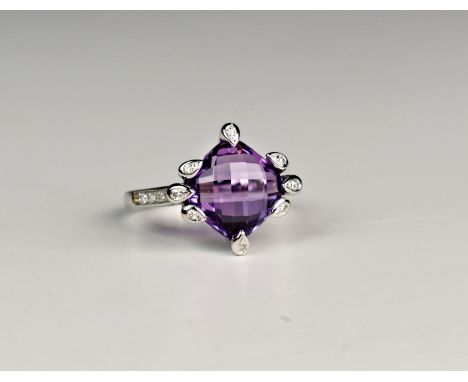 An 18ct white gold, amethyst and diamond ring, the cushion cut amethyst in an eight teardrop-claw setting, each claw set with