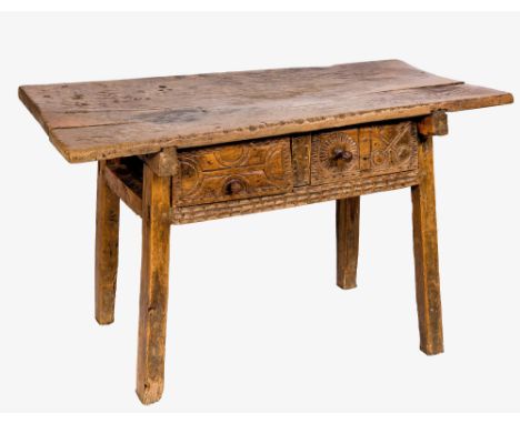 A 17th / 18th century Spanish joined carved walnut side table, the one piece rectangular top over two deep drawers with wine 