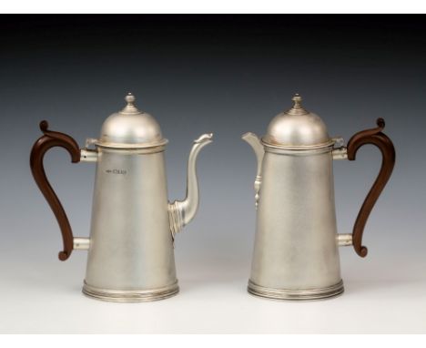 A George VI silver coffee pot and hot water jug, Collingwood & Co., London 1949, of plain early Georgian form, the tapered bo