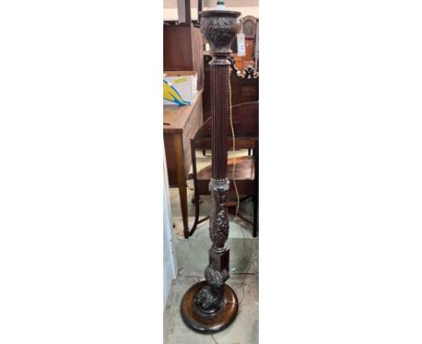 A carved oak and mahogany carved standard lamp, height 151cm *Please note the sale commences at 9am.