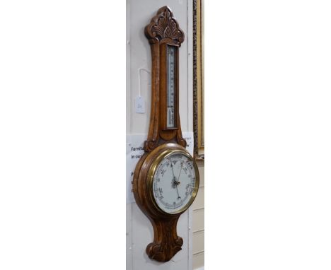 An Edwardian carved oak aneroid wheel barometer, 85cm *Please note the sale commences at 9am.
