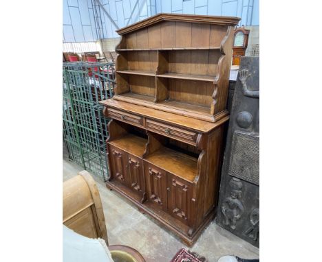 An Arts and Crafts pine buffet with arched top, width 150cm, depth 46cm, height 205cm *Please note the sale commences at 9am.