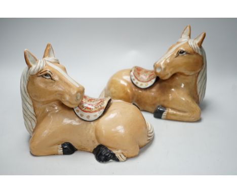 A pair of Chinese ceramic seated horses, 18cm high