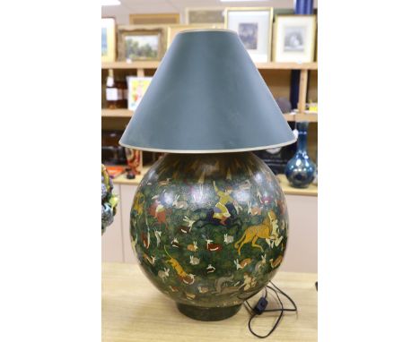 An Indian spherical green ground papier mache table lamp, decorated with hunting scenes and green shade, 75cms high including