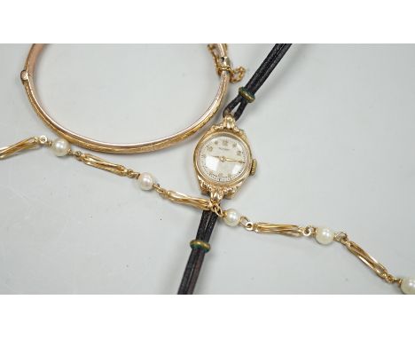 A modern 9ct gold and cultured pearl set bracelet, 18.5cm, a 9ct gold hinged bangle and a lady's yellow metal Rotary wrist wa