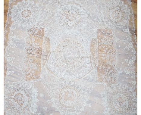 A late 19th century Normandy lace table cover of hand spun linen, hand white worked, with Brussels Point de Gaze insertions a