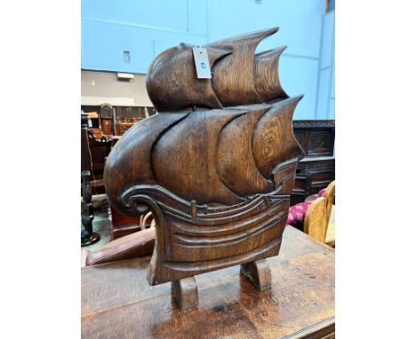 An Art Deco style carved oak firescreen in the shape of a ship, width 57cm, height 74cm *Please note the sale commences at 9a