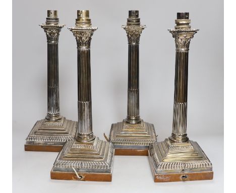 A set of four early 20th century silver plated Corinthian column table lamps on marble stands 33cms high (not including light