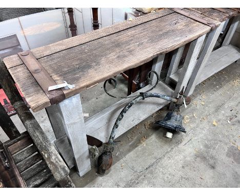 A pair of stained oak console tables with iron bound raw wood tops, width 132cm, depth 40cm, height 87cm *Please note the sal
