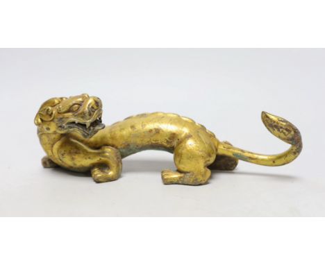 A Chinese gilt bronze figure of a dragon, Han or later, 25cm wide