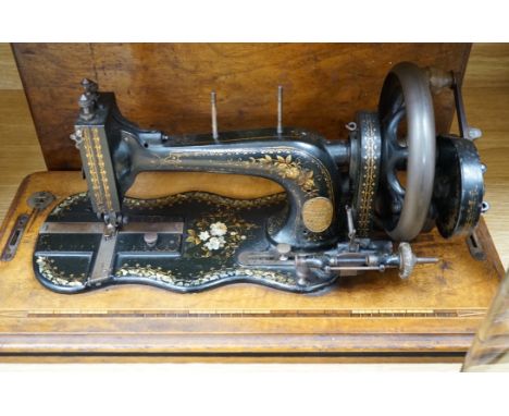 A 19th century mother of pearl decorated John Murdoch sewing machine with wooden case
