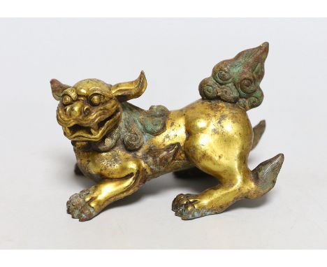 A Chinese gilt bronze figure of a lion dog, Han or later, 13cm wide