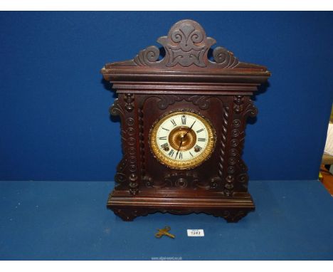 A Rosewood Mantle clock by the Ansonia Clock Co., New York, having circular face and Roman numerals and gilt surround, with k
