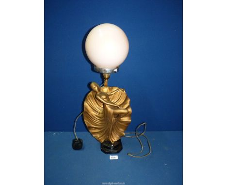 An Art Deco figure lamp having peach globe shade, 23" tall.