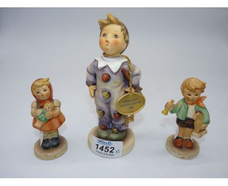 A Goebel Boy figure with toy horse and trumpet, Girl with doll and Boy in clowns costume.