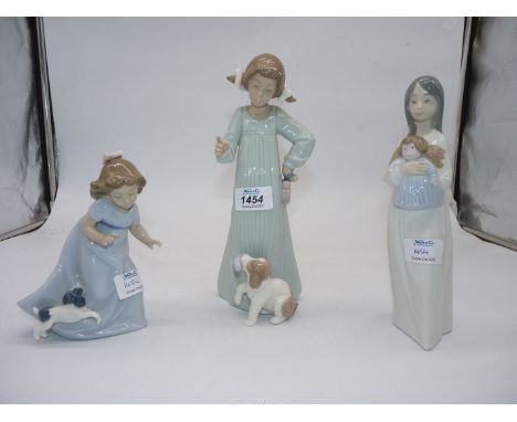 Three Nao figures:  Girl telling puppy off, 10 1/2" (boxed), Girl with rag doll, 9 1/3", Girl playing with puppy, 6 1/2".