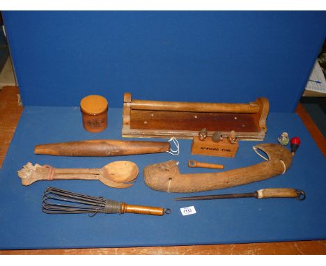 A quantity of kitchenalia including a rolling pin, a hand whisk, novelty bottle stoppers, corkscrews, a towel rail, a yoke, e