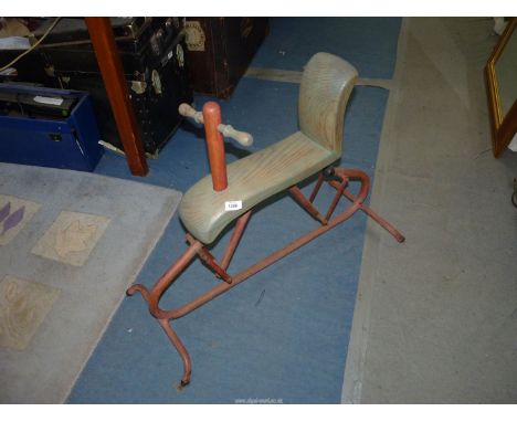 A wooden and metal child's rocker, 'Dunlop "Major" Patch Strip Outfit' label to back of seat.