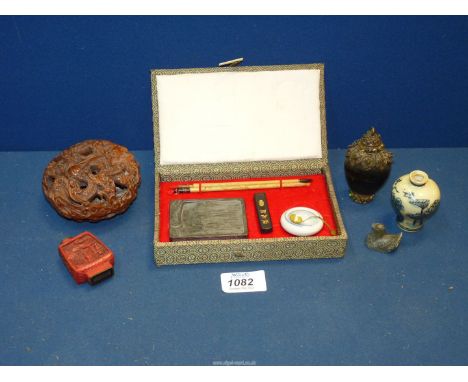 A variety of Chinese items including snuff bottles, calligraphy set, etc., in a small box.