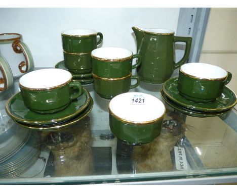 An Apilco dark green with gold decoration porcelain coffee set including six cups and saucers, milk jug and sugar bowl.