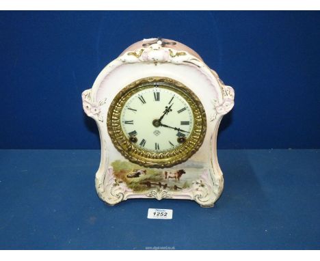 An Ansonia chiming Mantle Clock with Bonn china casing having Roman numerals to the cream face and the casing with scenes of 