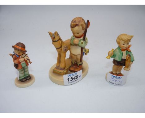 Three Goebel figures to include; boy with pull along horse, boy with trumpet on a horse and boy with violin. 3" - 4" tall.