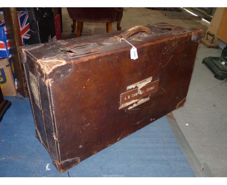 A large early 20th century quality Leather Suitcase with interior shelf and pouch and several old labels, 31" x 17" x 10" tal