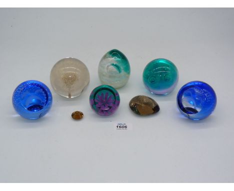 A quantity of Caithness paperweights to include dolphins, pink Dahlia, etc. and a Dandelion paperweight, etc.