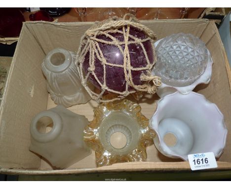 A quantity of glass lamp shades and a fishing float.