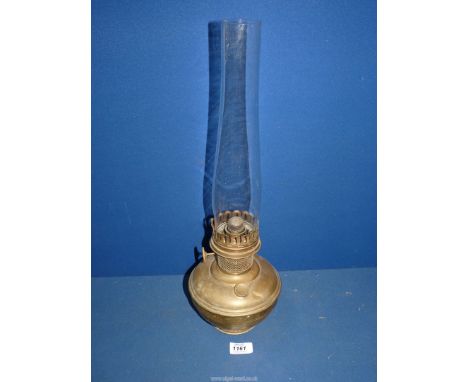 A brass Aladdin paraffin lamp with clear chimney, 20" tall.