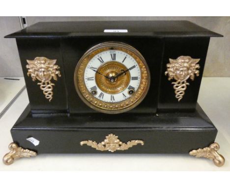 A black and gilt mantle clock with movement by the Ansonia Clock Co, USA