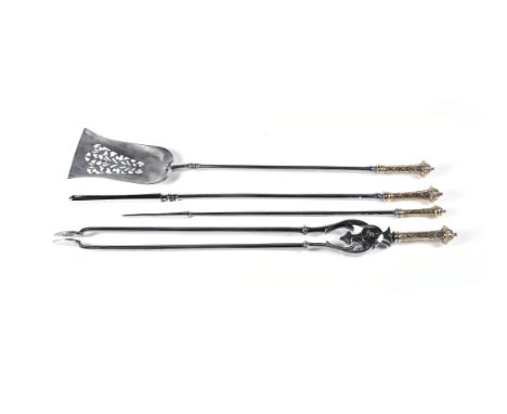 A suite of four William IV steel and brass mounted fire tools, in Gothic Revival taste, circa 1835, comprising shovel, poker,