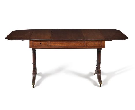 †  A Regency plum pudding mahogany sofa games table, circa 1815, in the manner of Gillows, the rectangular top incorporating 