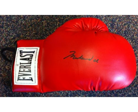 ALI MUHAMMAD: (1942- ) American Boxer, World Heavyweight Champion. A red Everlast size 10 boxing glove boldly signed ('Muhamm