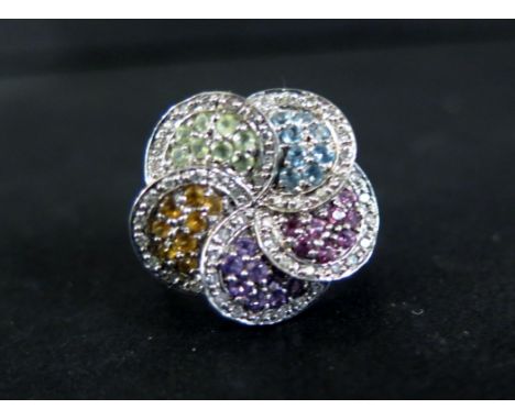 A 9ct gold diamond and multi-gem flower dress ring - Hallmarked London - Ring size N - Weight approx 6.0gms
Condition Report: