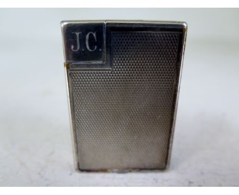 A silver plated Dunhill lighter, initials V.C to top