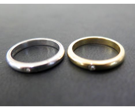 Two 18ct gold band rings - Each with brilliant-cut diamond highlight - Hallmarked London - Ring size J - Weight approx 6.9gms