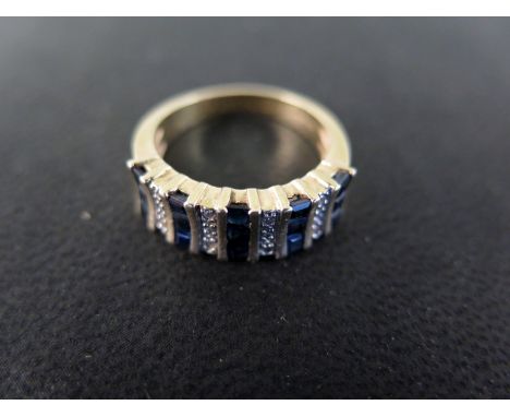 A 14ct yellow gold ring with sapphires and diamonds to shoulder - ring size O/P- approx weight 5.7 grams - in good condition,