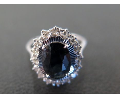 An 18ct white gold sapphire and diamond cluster ring - approx weight 4.2 grams - ring size J/K - in good condition, clean and