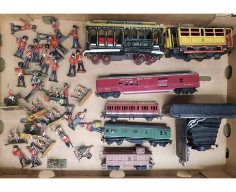 A mixed collection of items to include lead soldiers, vintage Eastman Kodak bellows camera, tin plate musical tram, Tri-Ang a