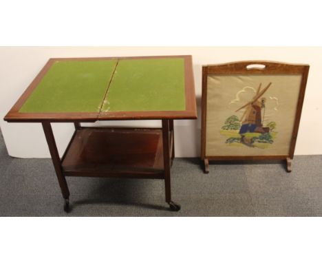 A 1940's mahogany tea trolley opening to a games table, W. 60cm H. 71cm together with an oak tapestry fire screen.