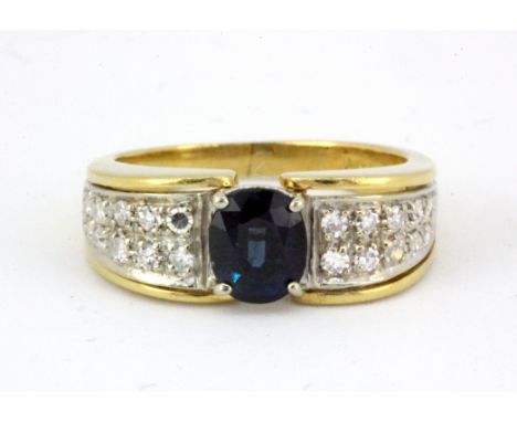 An 18ct yellow gold (stamped 18k) ring set with an oval cut sapphire and diamonds, (K.5).